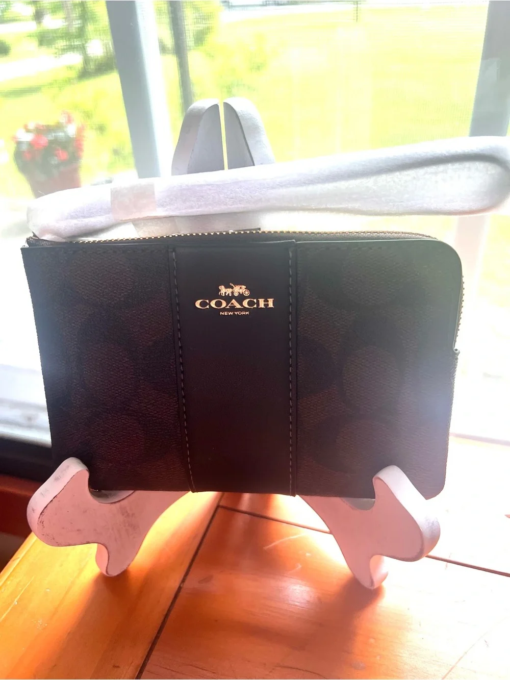 COACH corner zip wristlet in signature C pattern brown and black
